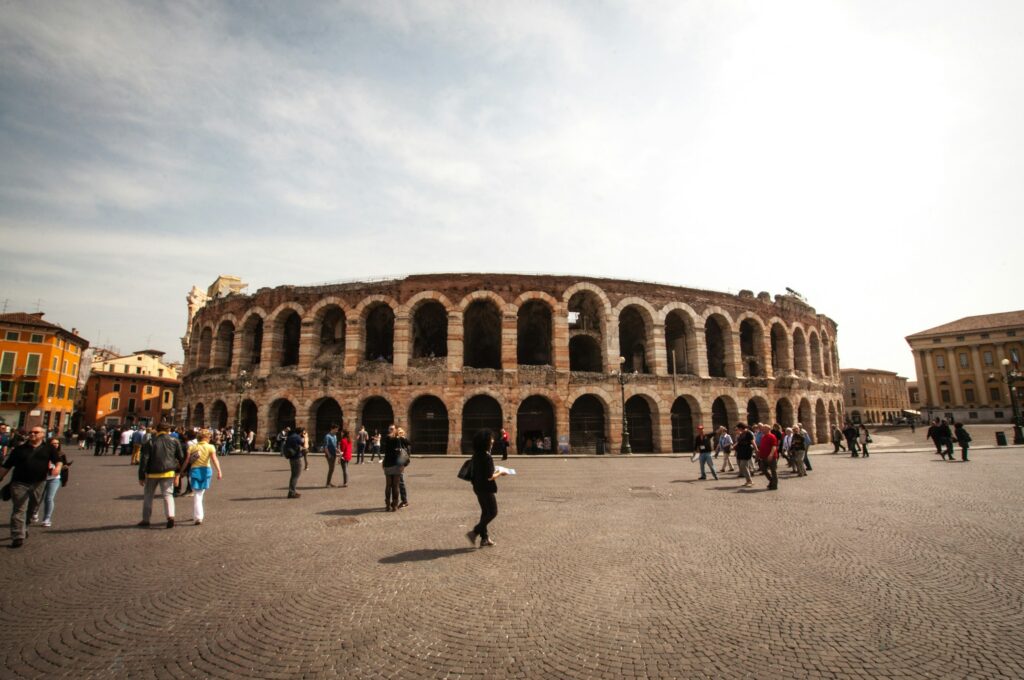 the Verona Arena with tourists walking by