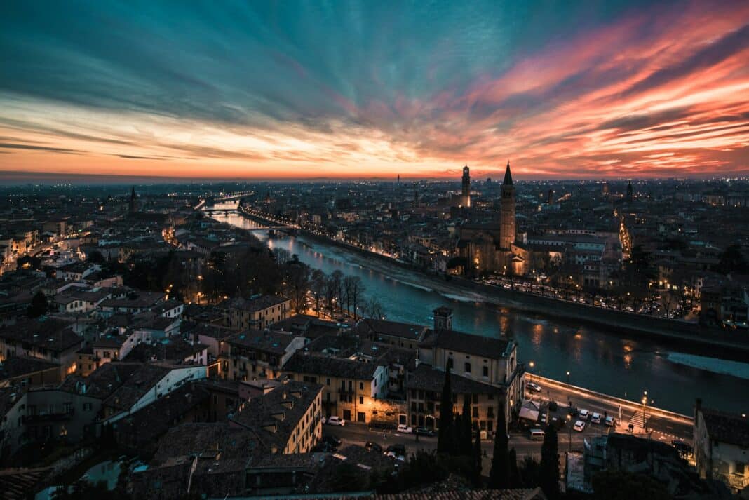 Verona, Italy seen from an aerial view at sunset as the city lights come on