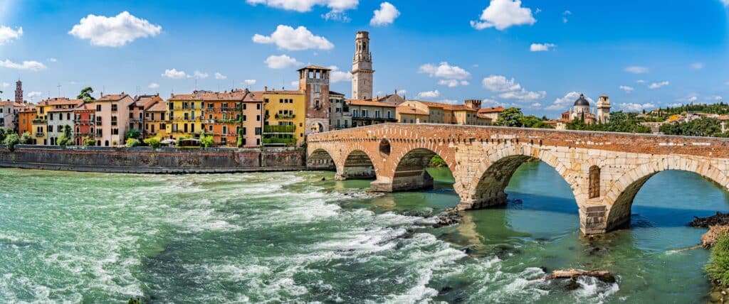 The Ponte Pietra bridge stretches across the Adige River in the Veronetta neighborhood of Verona