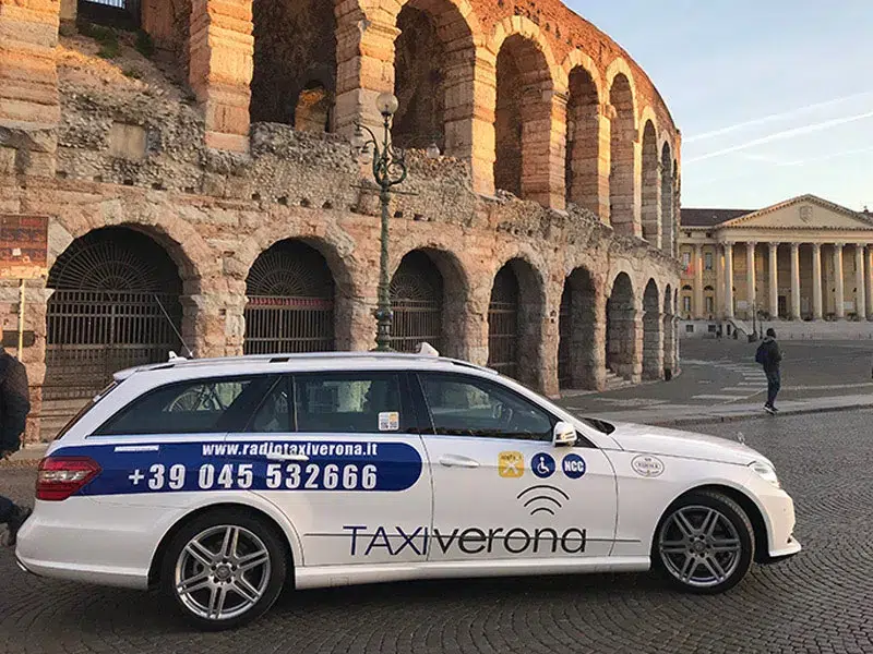 a taxi parked next to the Verona Arena