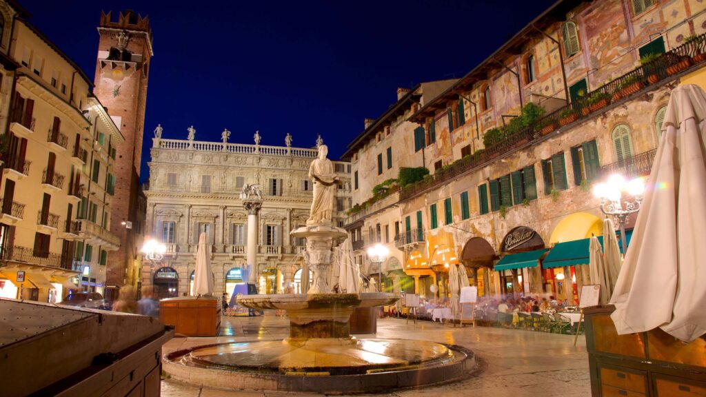 Piazza Erbe lit up at night with the statue of the Madonna Verona